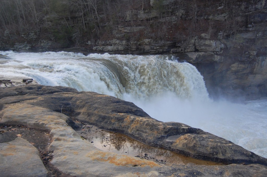 Cumberland Falls is a 68 foot / 21 meter tall waterfall that is 125 feet / 38 meters wide. This photo was taken in the winter months when there is no greenery.