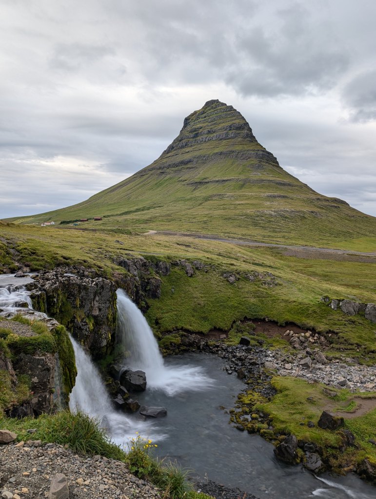 Kirkjufellsfoss is a waterfall in Icleand but the more prominent feature is Kirkjufell, a tall mountain/hill behind the waterfall.