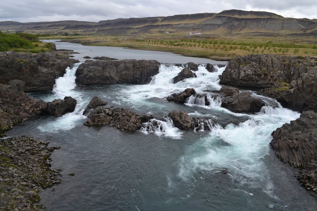 Glanni is a segmented waterfall across a wide river. There are multiple drops totaling probably 25 feet / 8 meters tall. 