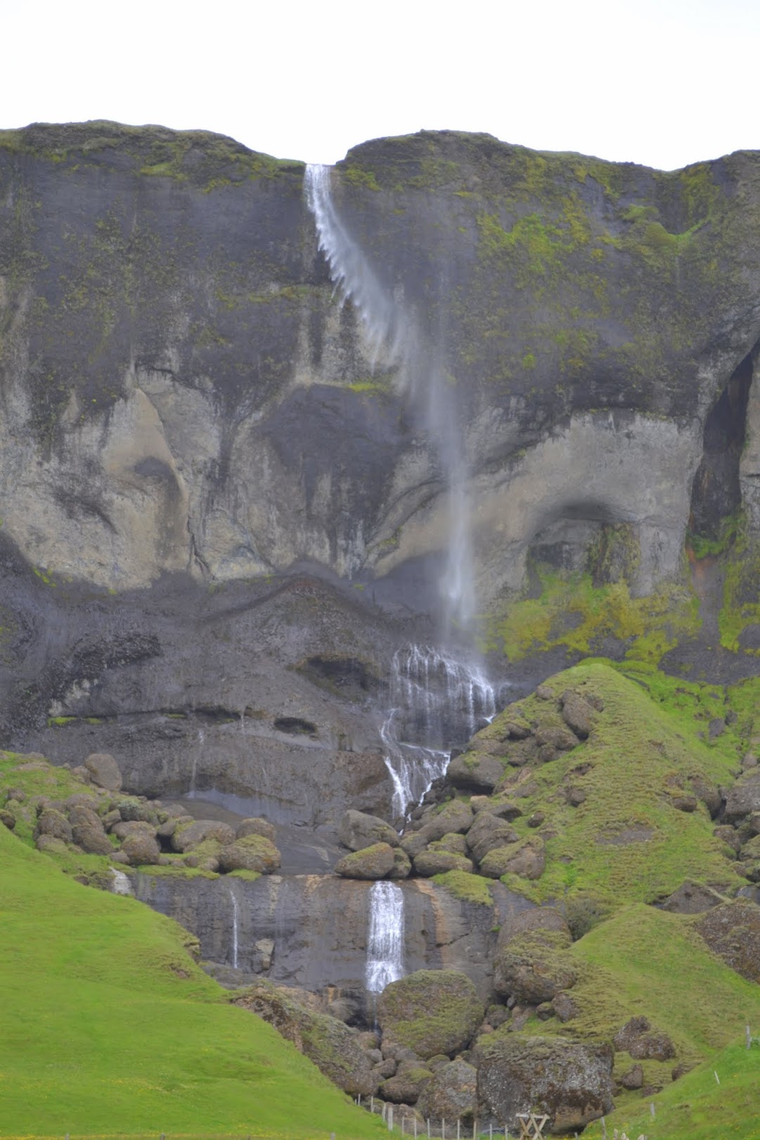 Foss á Siðu (Hamrafoss) is a 262 foot / 82 meter tall waterfall that can be viewed and heard from Iceland's Ring Road. The waterfall is blown by the wind as it plunges down the basalt cliffs.