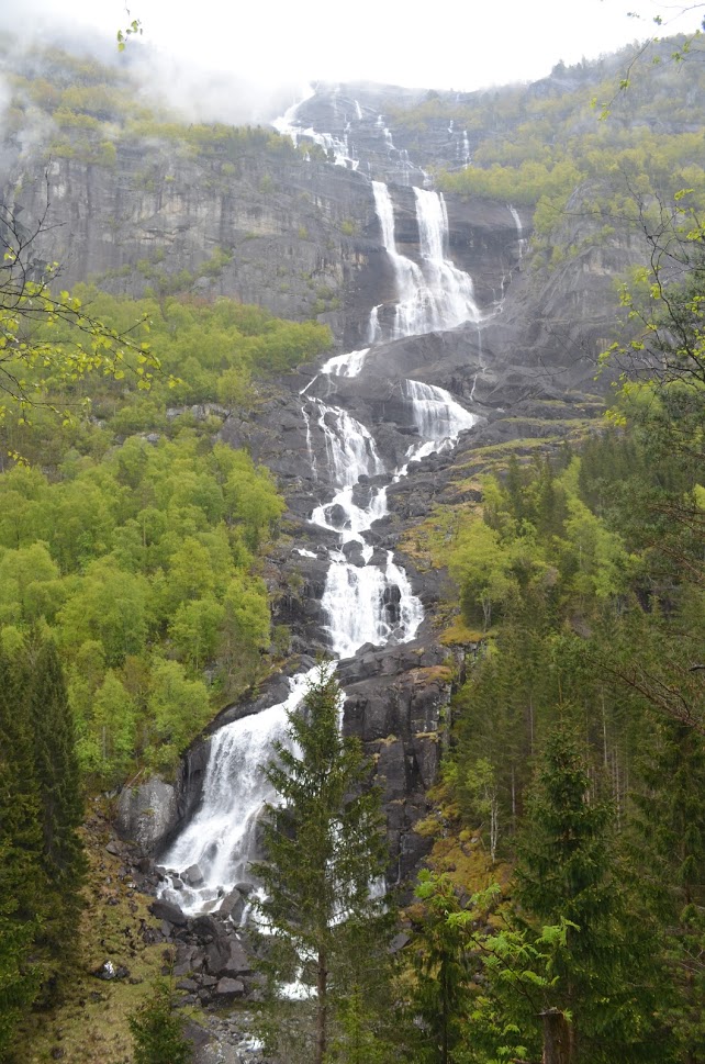 Tjørnadalsfossen is a 1657 foot / 505 meter tall waterfall. It is so tall in an area that receives a lot of rainfall that you can see the clouds at the top of the falls.