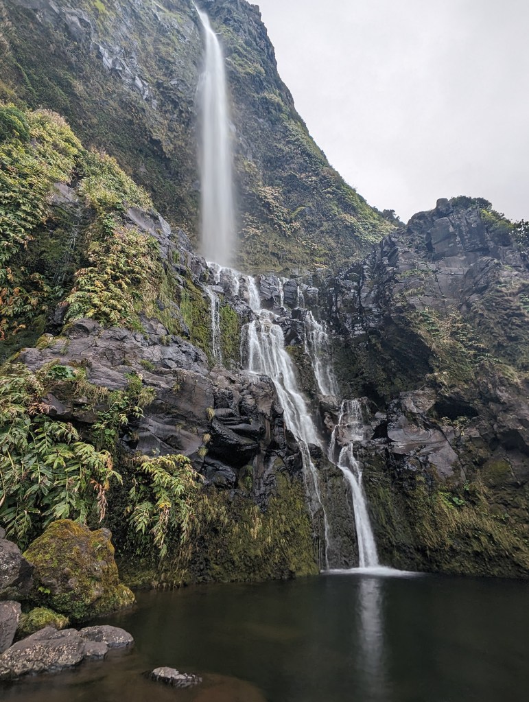 Cascata do Poço do Bacalhau is a 300 foot / 90 meter tall waterfall on the island of Flores, part of the Azores.
