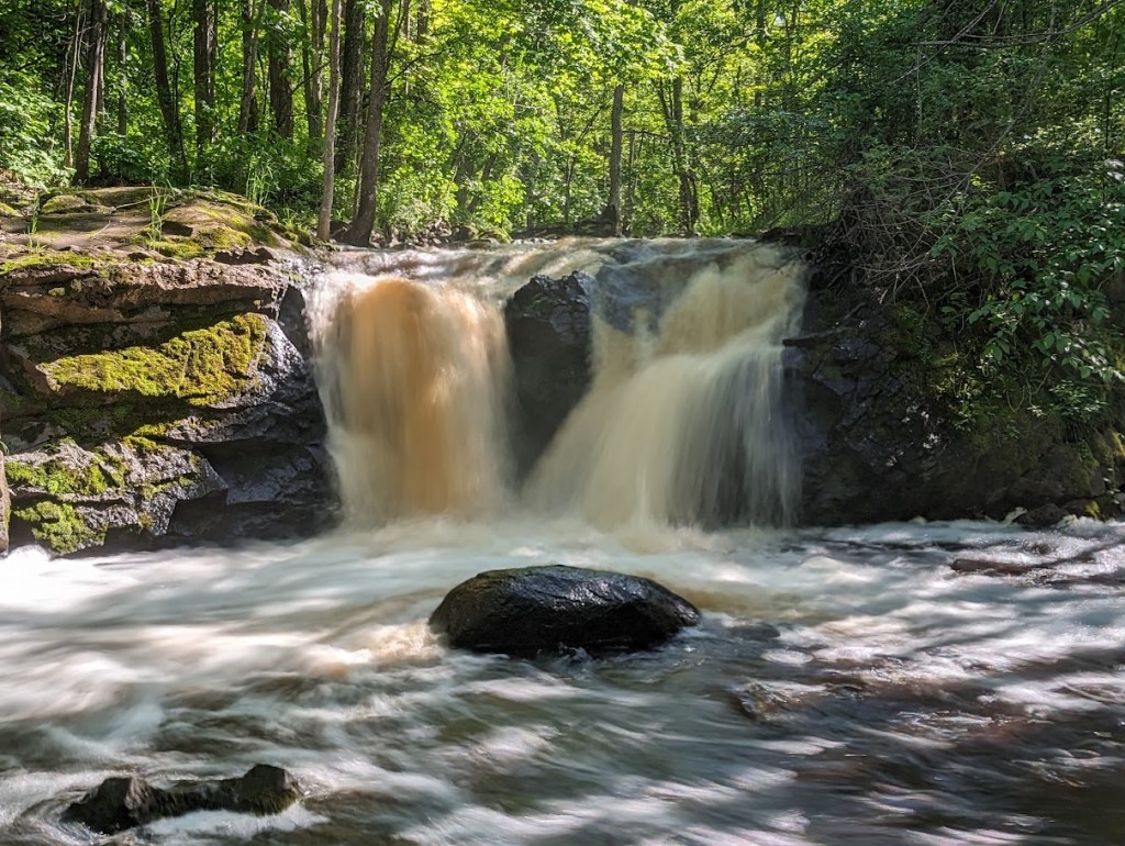 This is a 6 foot waterfall in the Upper Peninsula of Michigan called Root Beer Falls. The water has a different color than water in other creeks or rivers.