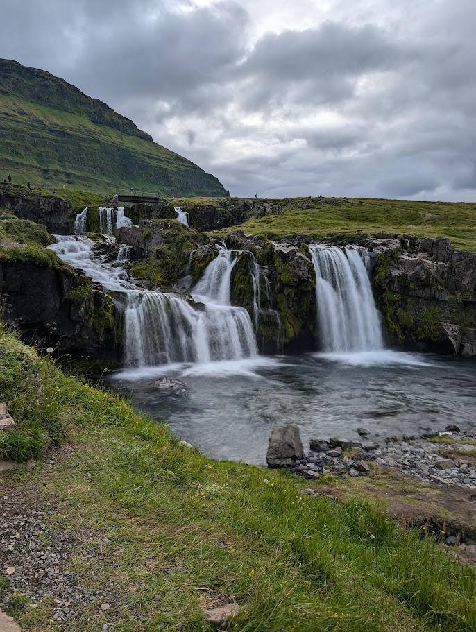 This is Kirkjufellsfoss, a waterfall in Iceland. There are two drops along the river and the total height is 54 feet (16 meters).
