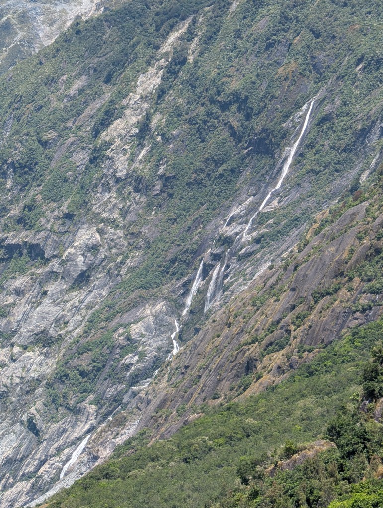 This is a much taller, 300 foot / 90 meter waterfall that is rather narrow and cascades down the same rock slopes.
