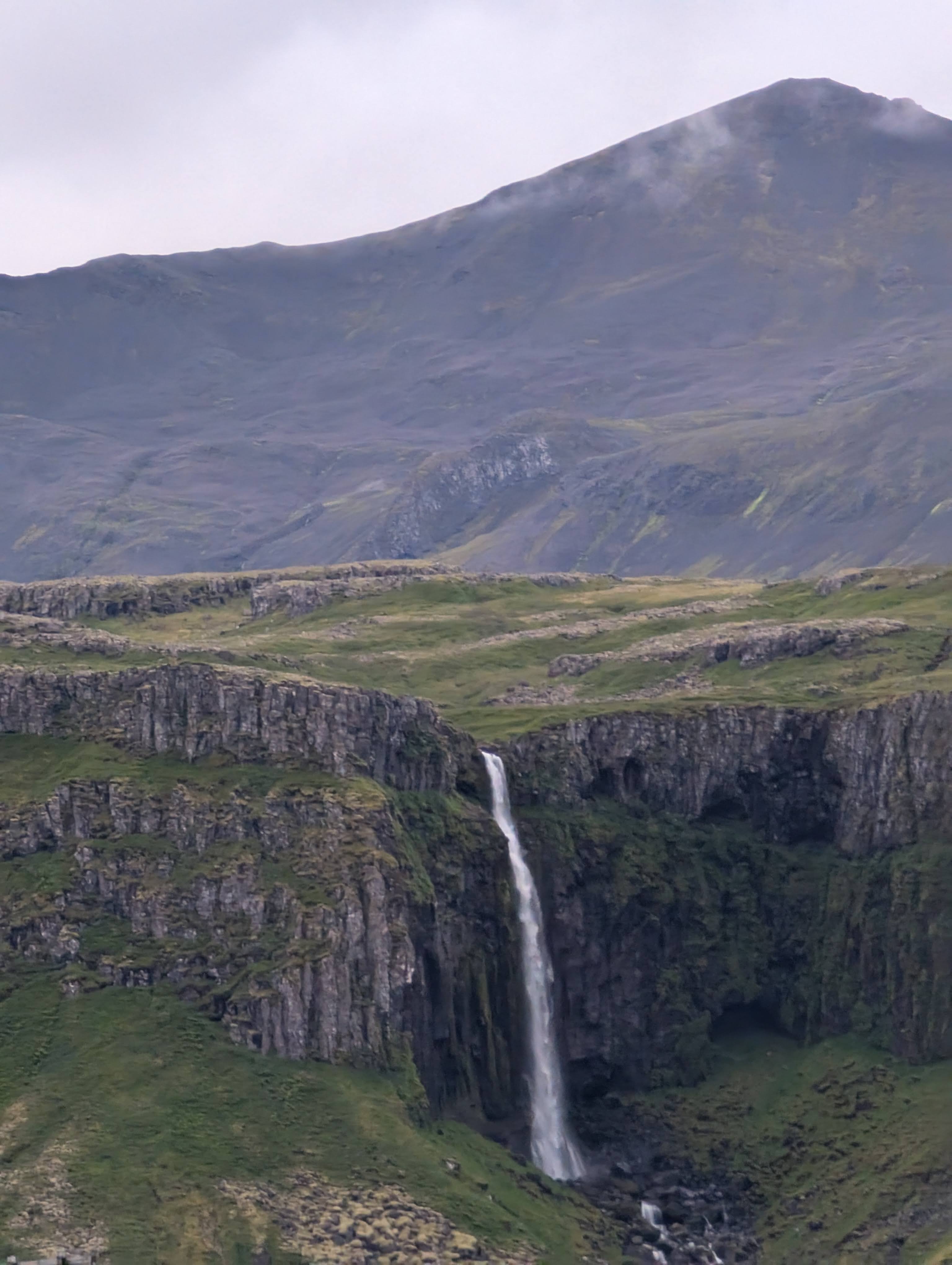 Grundarfoss is a 230 foot / 70 meter tall waterfall that plunges over basalt cliffs on the Snæfellsnes Peninsula in Iceland.